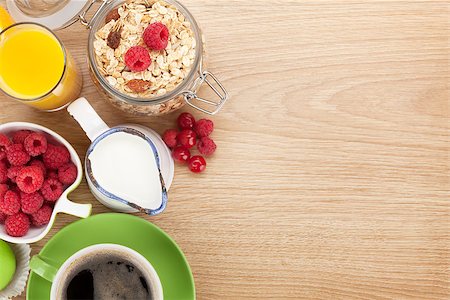 porridge and berries - Healty breakfast with muesli, berries, orange juice, coffee and croissant. View from above on wooden table with copy space Stock Photo - Budget Royalty-Free & Subscription, Code: 400-08293260