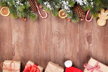 simsearch:400-07179654,k - Christmas wooden background with snow fir tree, decor and gift boxes Photographie de stock - Aubaine LD & Abonnement, Code: 400-08293363