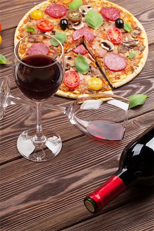 simsearch:400-08960199,k - Italian pizza with pepperoni, tomatoes, olives, basil and red wine on wooden table. Top view Stock Photo - Budget Royalty-Free & Subscription, Code: 400-08293417