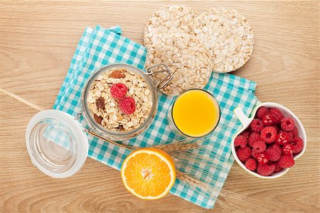 porridge and berries - Healthy breakfast with muesli, berries and orange juice. On wooden table Stock Photo - Budget Royalty-Free & Subscription, Code: 400-08293425