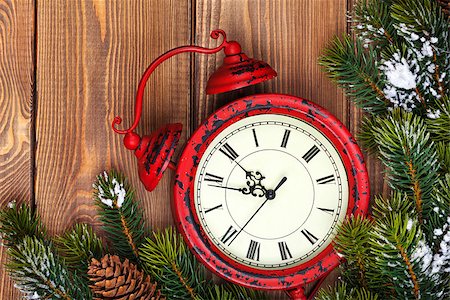 Christmas clock and snow fir tree over wooden background Stock Photo - Budget Royalty-Free & Subscription, Code: 400-08293529