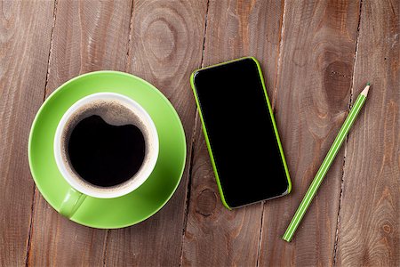 simsearch:400-08252729,k - Smartphone and green coffee cup on wooden table. Top view Stock Photo - Budget Royalty-Free & Subscription, Code: 400-08293520