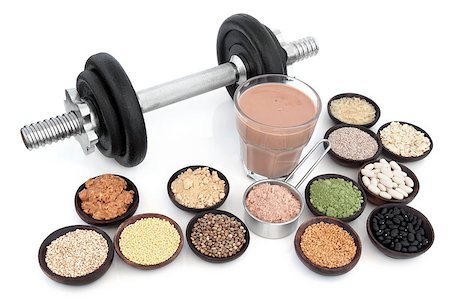 Body building dumbbells with health and super food of chocolate whey, red maca and wheat grass supplement powders, pulses, seeds, nuts, grains and protein shake over white background. Stock Photo - Budget Royalty-Free & Subscription, Code: 400-08293934