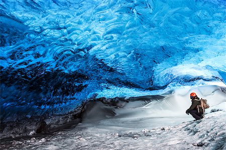 Man traveler enjoying exotic landmark, sitting in the ice cave, Skaftafell glacier, Vatnajokull National park, amazing nature of Iceland Photographie de stock - Aubaine LD & Abonnement, Code: 400-08300084