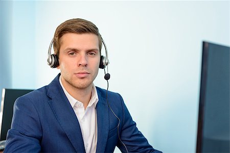 simsearch:400-05710310,k - Young Customer Support Phone Operator with Headset at his Working Place in the Office. Stock Photo - Budget Royalty-Free & Subscription, Code: 400-08300690