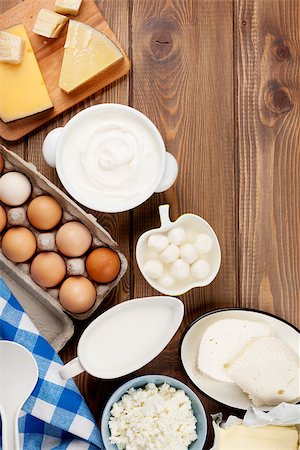 simsearch:400-07825089,k - Dairy products on wooden table. Sour cream, milk, cheese, eggs, yogurt and butter. Top view with copy space Fotografie stock - Microstock e Abbonamento, Codice: 400-08300716