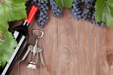 simsearch:400-08110621,k - Red grape, wine bottle and corkscrew on wooden table. Top view with copy space Stock Photo - Budget Royalty-Free & Subscription, Code: 400-08300733