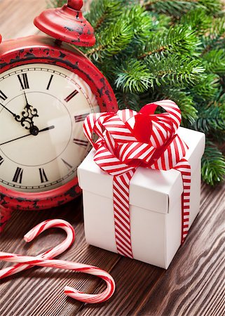 simsearch:400-04241664,k - Christmas alarm clock, gift box and fir tree branch on wooden table Stock Photo - Budget Royalty-Free & Subscription, Code: 400-08300796