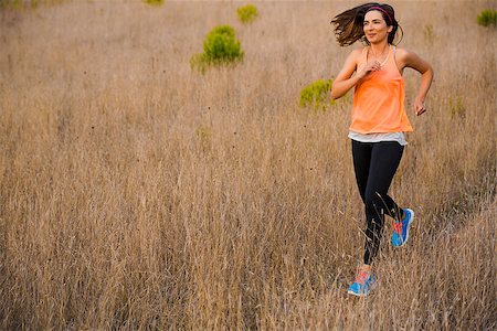 simsearch:400-07682342,k - Shot of an attractive woman running outdoor on a meadow Stock Photo - Budget Royalty-Free & Subscription, Code: 400-08300894
