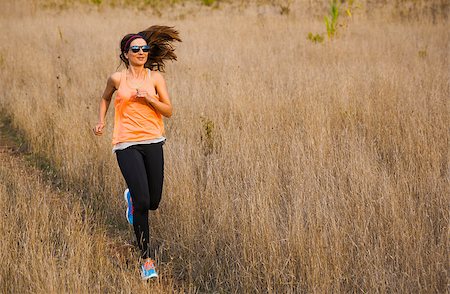 simsearch:400-07682342,k - Shot of an attractive woman running outdoor on a meadow Stock Photo - Budget Royalty-Free & Subscription, Code: 400-08300891