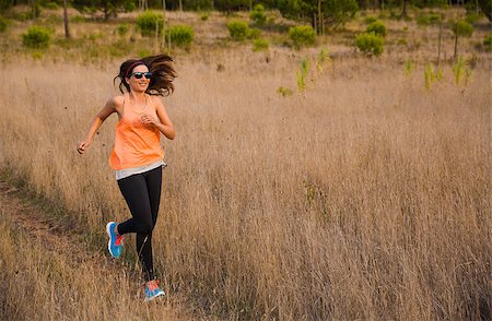 simsearch:400-07682342,k - Shot of an attractive woman running outdoor on a meadow Stock Photo - Budget Royalty-Free & Subscription, Code: 400-08300892