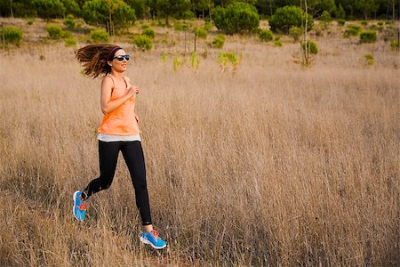 simsearch:400-07682342,k - Shot of an attractive woman running outdoor on a meadow Stock Photo - Budget Royalty-Free & Subscription, Code: 400-08300893