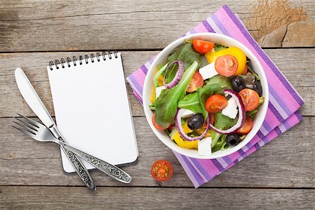 simsearch:400-06485512,k - Fresh healthy salad and notepad for copy space and silverware on wooden table. View from above Stock Photo - Budget Royalty-Free & Subscription, Code: 400-08301815