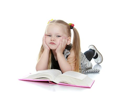 simsearch:400-06747549,k - Portrait of a little girl blondes who reads a book while lying on the floor - isolated on white background Foto de stock - Super Valor sin royalties y Suscripción, Código: 400-08314000