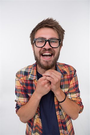 simsearch:6110-09101637,k - Close-up portrait of friendly young man big smiling. Man in glasses weighing his beard down with two hands. Stockbilder - Microstock & Abonnement, Bildnummer: 400-08314477