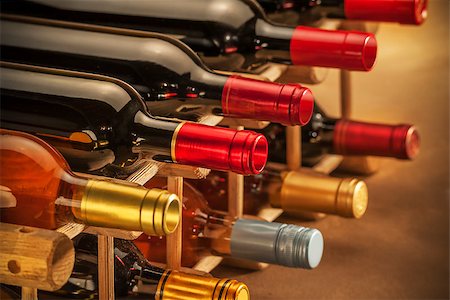 Wine bottles stacked together on an old master canvas with shallow depth of field Fotografie stock - Microstock e Abbonamento, Codice: 400-08314537