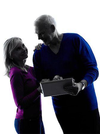 simsearch:400-08317008,k - one caucasian couple senior looking at  digital tablet computer  silhouette  in silhouette studio isolated on white background Stockbilder - Microstock & Abonnement, Bildnummer: 400-08314697