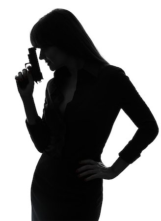 one  sexy detective woman holding aiming gun in silhouette studio isolated on white background Photographie de stock - Aubaine LD & Abonnement, Code: 400-08314875