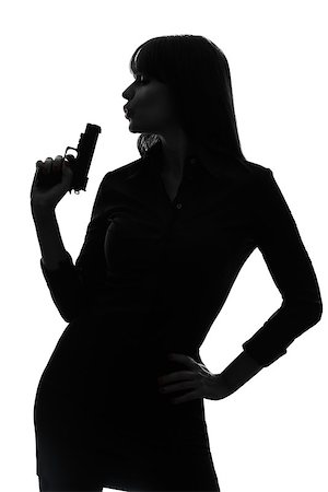 police detective standing - one  sexy detective woman holding aiming gun in silhouette studio isolated on white background Stock Photo - Budget Royalty-Free & Subscription, Code: 400-08314876