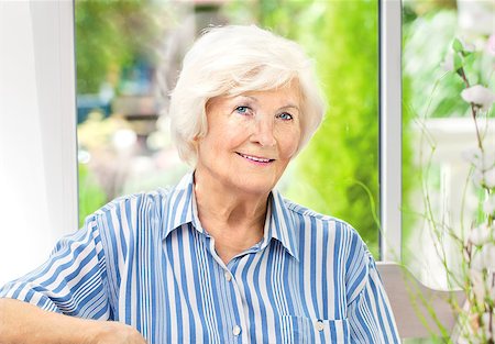 Beautiful senior woman sitting in her winter garden , in the background the garden Fotografie stock - Microstock e Abbonamento, Codice: 400-08315073