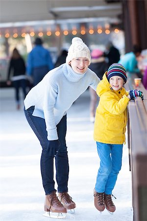 simsearch:400-08318057,k - young mother teaching her positive son ice skating, enjoying winter time at outdoor skating rink together Stock Photo - Budget Royalty-Free & Subscription, Code: 400-08315867