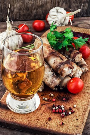 fragrant grilled meat sausages in tomato with a glass of light beer.Selective focus.Photo tinted Stock Photo - Budget Royalty-Free & Subscription, Code: 400-08316536