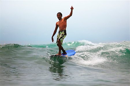 simsearch:400-04476949,k - Young men - the surfer in ocean. Bali. Indonesia Photographie de stock - Aubaine LD & Abonnement, Code: 400-08316598