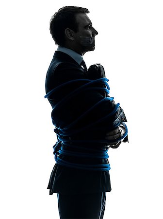 one  business man tied up prisoner in silhouette studio isolated on white background Stock Photo - Budget Royalty-Free & Subscription, Code: 400-08316830