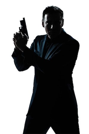 simsearch:400-07097770,k - one  spy criminal policeman detective man holding gun portrait silhouette in studio isolated white background Photographie de stock - Aubaine LD & Abonnement, Code: 400-08316987