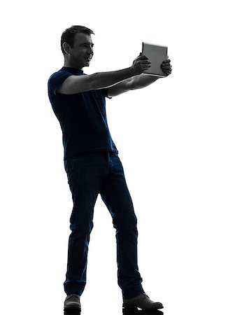 simsearch:400-08317008,k - one  man holding watching digital tablet in silhouette on white background Stockbilder - Microstock & Abonnement, Bildnummer: 400-08317007