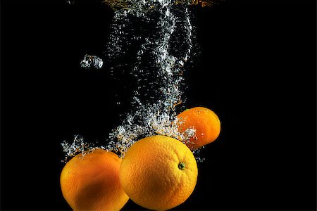 fruit underwater - Oranges in water with air bubbles. Wash fruits. Photo on a black background. High speed photography. Stock Photo - Budget Royalty-Free & Subscription, Code: 400-08317656