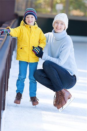 simsearch:400-08318057,k - young mother teaching her positive son ice skating, enjoying winter time at outdoor skating rink together Stock Photo - Budget Royalty-Free & Subscription, Code: 400-08318028