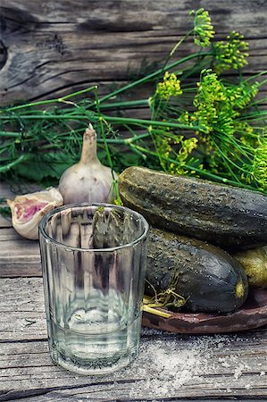 simsearch:400-04229428,k - Pickled cucumbers with dill and vodka shot glass on wooden background in country style.Photo tinted.Selective focus Stock Photo - Budget Royalty-Free & Subscription, Code: 400-08318097