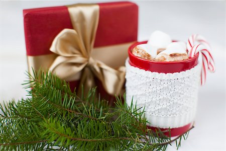 close-up of christmas themed decoration - wrapped present, cup with hot cocoa, marshmallows, candy canes and tree branch Stock Photo - Budget Royalty-Free & Subscription, Code: 400-08319219