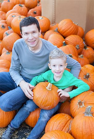 simsearch:400-08319221,k - cheerful little boy and his young father holding pumpkin enjoying halloween time at pumpkin patch Photographie de stock - Aubaine LD & Abonnement, Code: 400-08319225