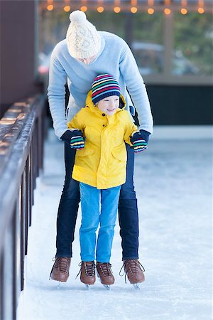 simsearch:400-08034847,k - family of two enjoying winter time ice skating together at outdoor skating rink Photographie de stock - Aubaine LD & Abonnement, Code: 400-08319222