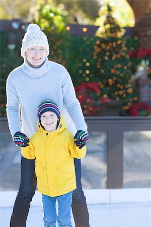 simsearch:400-08034847,k - young smiling mother and her cheerful son enjoying ice skating together at outdoor skating rink at christmas time Photographie de stock - Aubaine LD & Abonnement, Code: 400-08319493