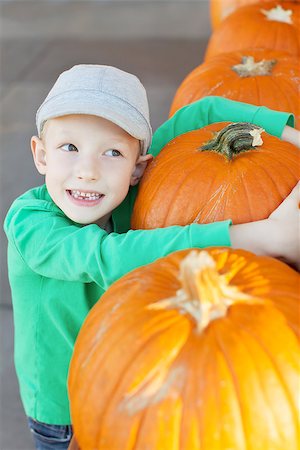 simsearch:400-07211170,k - cheerful little boy holding pumpkin enjoying halloween time at pumpkin patch Photographie de stock - Aubaine LD & Abonnement, Code: 400-08319522