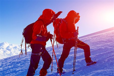 hiker at the top of a pass with backpacks meeting the sunrise in the mountains Stock Photo - Budget Royalty-Free & Subscription, Code: 400-08313937