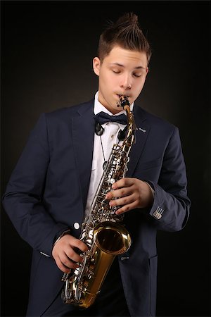 simsearch:400-06134635,k - Photo of a teenager and his saxophone. Professional musician preparing for concert. Stock Photo - Budget Royalty-Free & Subscription, Code: 400-08313989