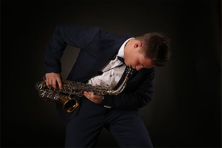 simsearch:400-06134635,k - Photo of a teenager and his saxophone. Professional musician preparing for concert. Stock Photo - Budget Royalty-Free & Subscription, Code: 400-08313990