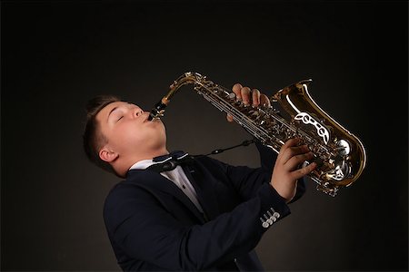 simsearch:400-06134635,k - Photo of a teenager and his saxophone. Professional musician preparing for concert. Stock Photo - Budget Royalty-Free & Subscription, Code: 400-08313992