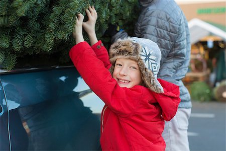 happy family buying christmas tree together at christmas market and lifting the tree on top of the car Stock Photo - Budget Royalty-Free & Subscription, Code: 400-08320100