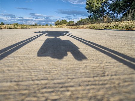 shadow of a hexacopter drone taking off with a camera from a concrete pathway Stock Photo - Budget Royalty-Free & Subscription, Code: 400-08334223