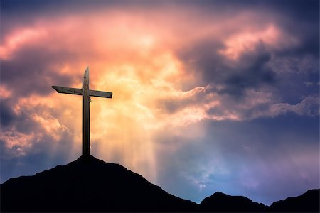 Silhouette of cross at sunrise or sunset with light rays Stock Photo - Budget Royalty-Free & Subscription, Code: 400-08334431