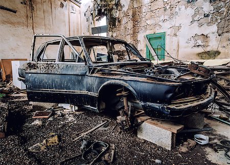 scrap yard vintage cars - Old wrecked car inside of ruinous building Stock Photo - Budget Royalty-Free & Subscription, Code: 400-08334879