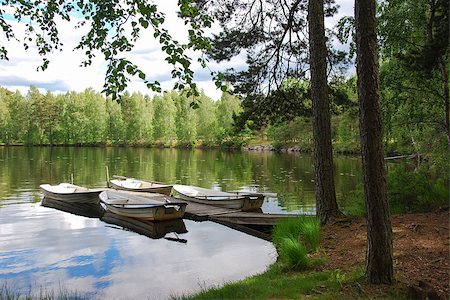 Rowing boats by an old wooden pier in a calm bay in a swedish lake in the woodlands Foto de stock - Super Valor sin royalties y Suscripción, Código: 400-08335429
