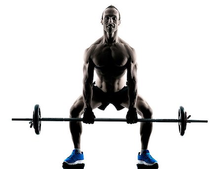 squats dumbbells - one caucasian man exercising fitness body building exercises in studio in silhouette isolated Stock Photo - Budget Royalty-Free & Subscription, Code: 400-08335580