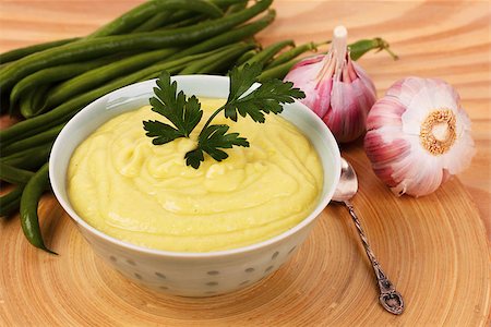 simsearch:400-07298426,k - Vegetable cream soup of green beans with parsley  and garlic on wooden table. Selective focus Stock Photo - Budget Royalty-Free & Subscription, Code: 400-08336554