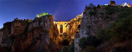 illuminated  Puente Nuevo Bridge from outskirts of Ronda at sunset, Spain. Panoramic view Photographie de stock - Aubaine LD & Abonnement, Code: 400-08337022
